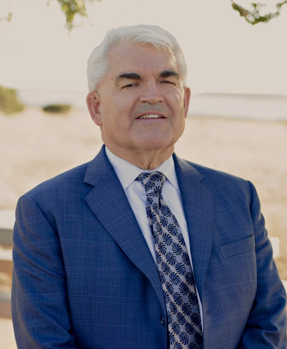 Attorney Bill Ross Attorney Bill Ross, wearing a blue suit and patterned tie outdoors.
